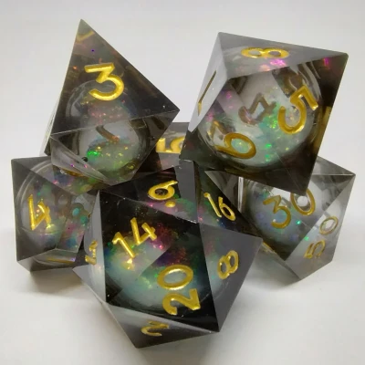 Liquid Core Maelstrom of Dreams dice kit - black and gold in a bottle with screw-cap