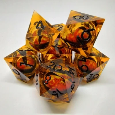 Liquid Core Dragon Eye dice kit - orange with black numbers in a bottle with screw-cap