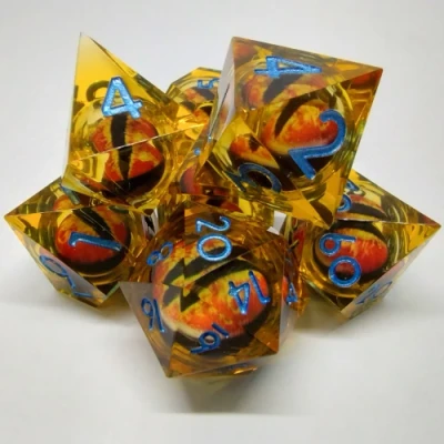 Liquid Core Dragon Eye dice kit - orange with blue numbers in a bottle with screw-cap