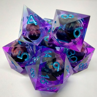 Liquid Core Dragon Eye dice kit - blue / purple with blue numbers in a bottle with screw-cap