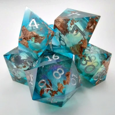 Liquid Core Maelstrom of Dreams dice kit - sky blue with bronze foil in a bottle with screw-cap